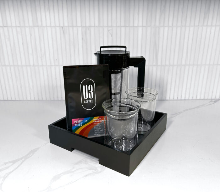 Gift Tray including 12 oz bag of U3 Perfectly Wired whole bean coffee, black Takeya cold brew coffee maker, Fellow Stagg Tasting Glasses on a black serving tray.